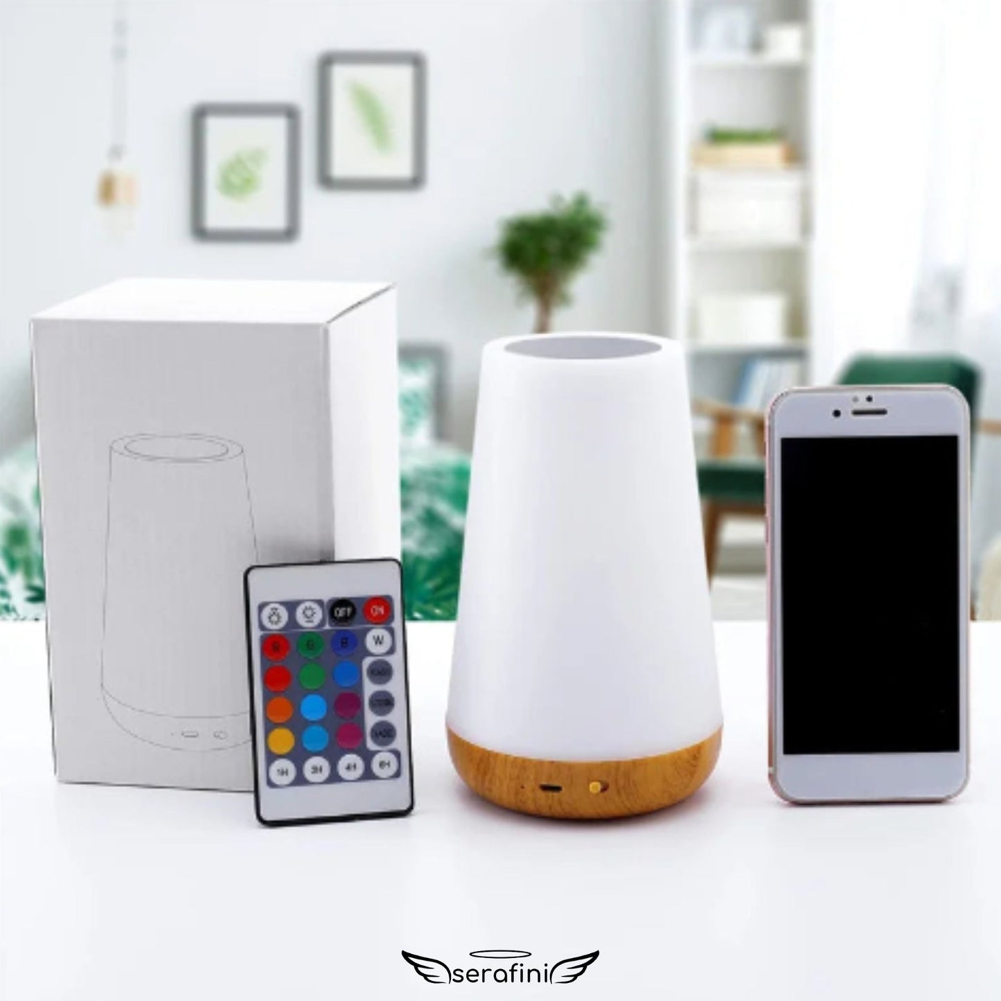 Foto da luminária em cima de um móvel branco, com a caixa ao lado e o controle remoto enconstado na caixa e um celular branco ao lado.